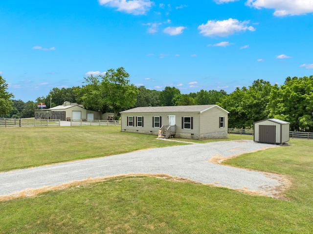 back of property with a shed and a yard