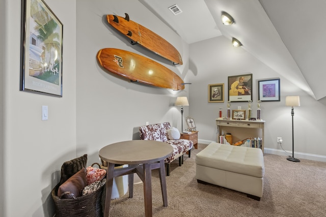 living area featuring carpet floors and vaulted ceiling