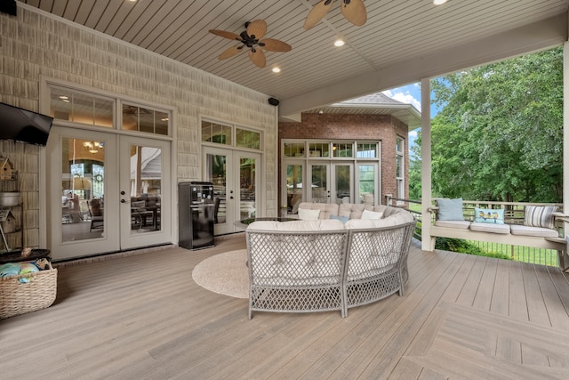 wooden deck featuring french doors, ceiling fan, and an outdoor hangout area