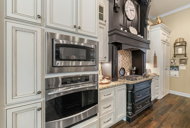 kitchen with stainless steel appliances, white cabinets, crown molding, dark hardwood / wood-style floors, and light stone countertops