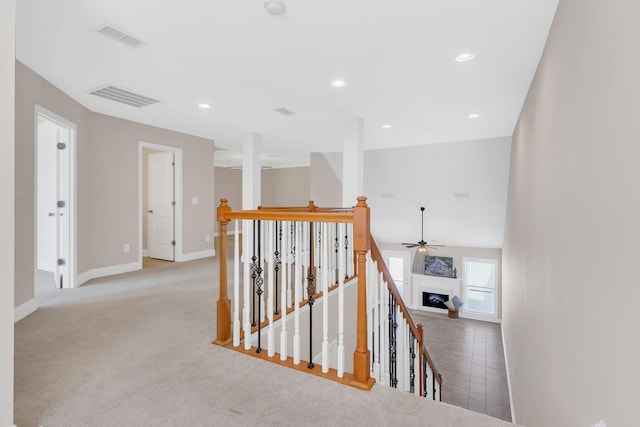 hallway featuring light colored carpet