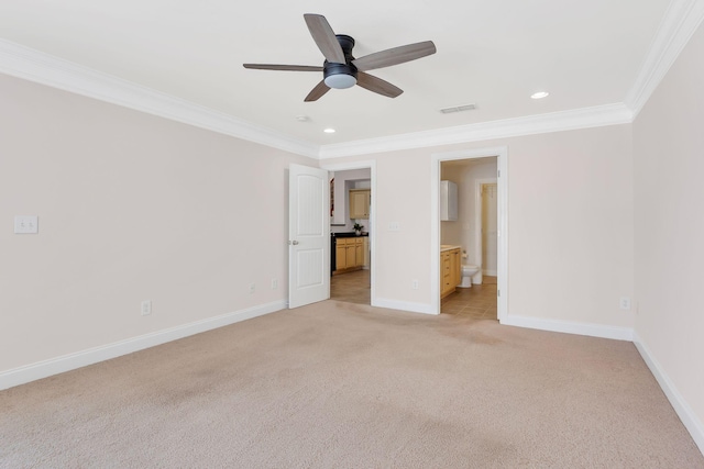 unfurnished bedroom featuring light carpet, crown molding, ensuite bath, and ceiling fan