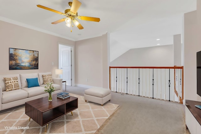 carpeted living room with ornamental molding and ceiling fan