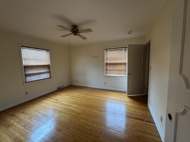 unfurnished room featuring light wood-type flooring, ceiling fan, and ornamental molding