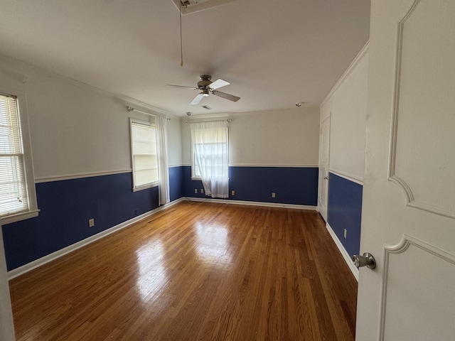 unfurnished room with ceiling fan, wood-type flooring, and crown molding