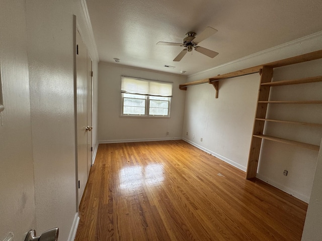 unfurnished bedroom featuring light wood-type flooring, ceiling fan, and ornamental molding