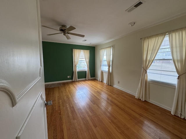 unfurnished room featuring ceiling fan, crown molding, and light hardwood / wood-style flooring