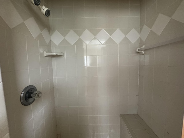 bathroom with a tile shower