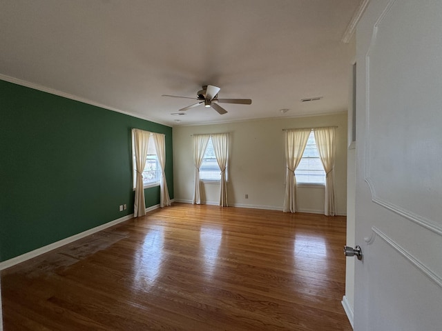 unfurnished room featuring ceiling fan, light wood-type flooring, and ornamental molding