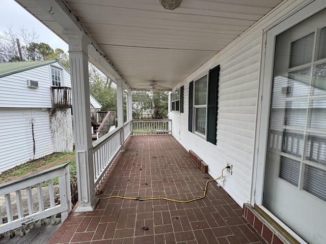 wooden deck featuring ceiling fan and a porch