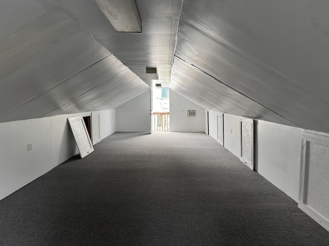 bonus room with carpet flooring and lofted ceiling