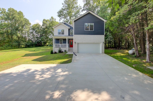 view of front property featuring a front yard, covered porch, and a garage