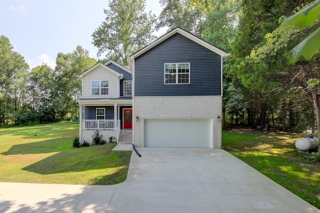 view of property with covered porch, a garage, and a front lawn