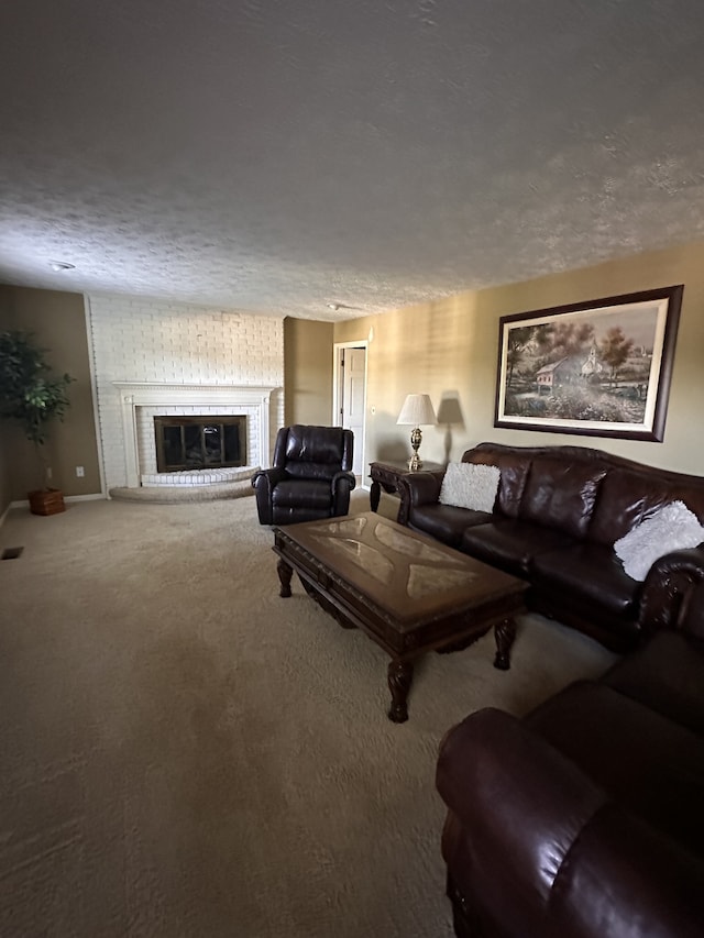 carpeted living room featuring a brick fireplace and a textured ceiling