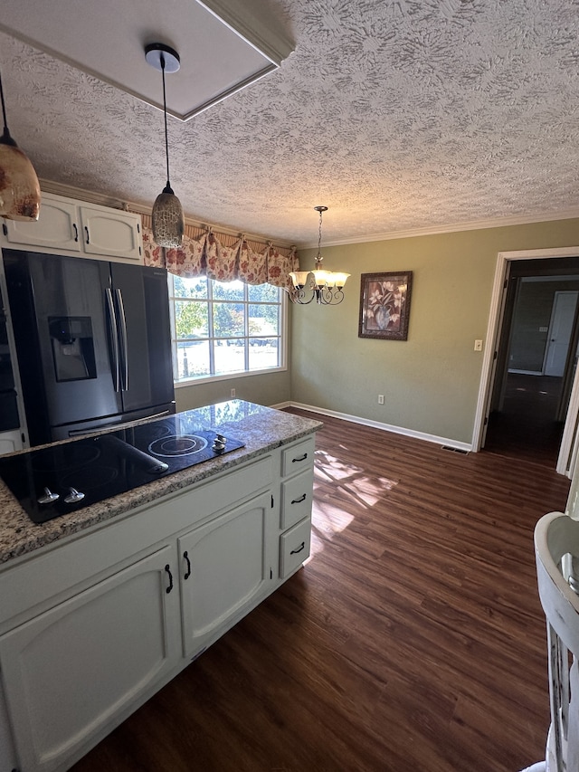 kitchen featuring fridge with ice dispenser, dark wood-type flooring, black electric cooktop, decorative light fixtures, and white cabinets