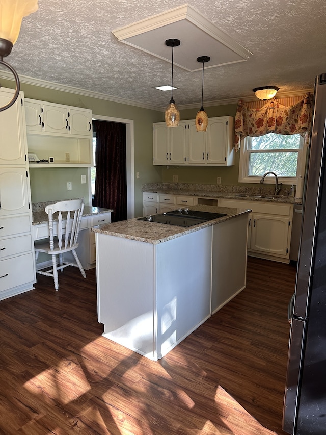 kitchen featuring white cabinetry, black electric cooktop, stainless steel refrigerator, dark hardwood / wood-style floors, and a center island