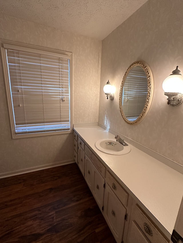 bathroom with vanity, hardwood / wood-style floors, and a textured ceiling