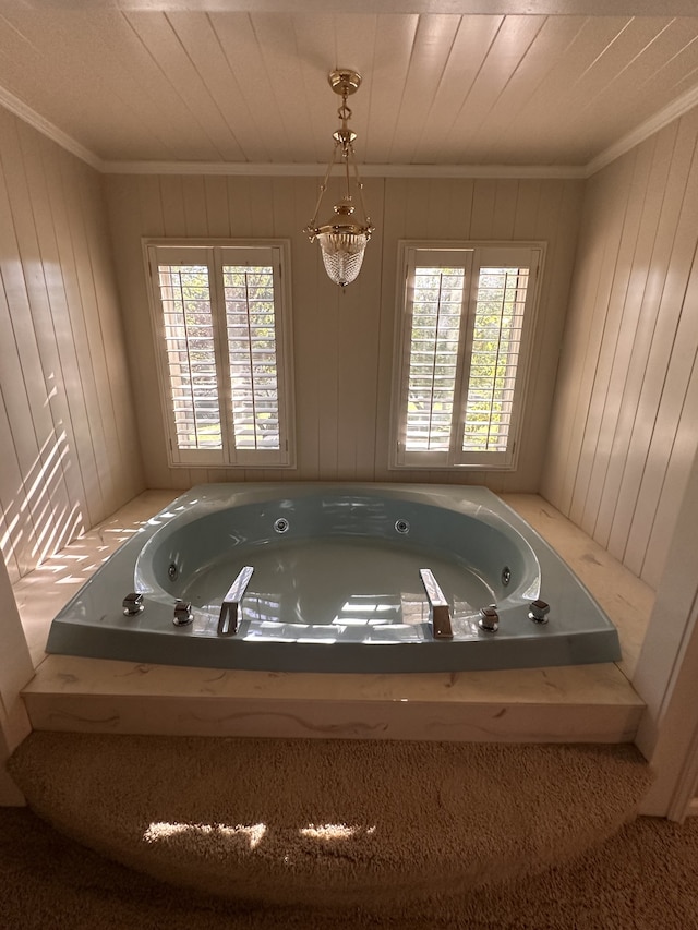 bathroom featuring a bathtub, plenty of natural light, and ornamental molding