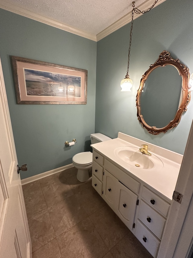 bathroom featuring tile patterned flooring, toilet, ornamental molding, vanity, and a textured ceiling