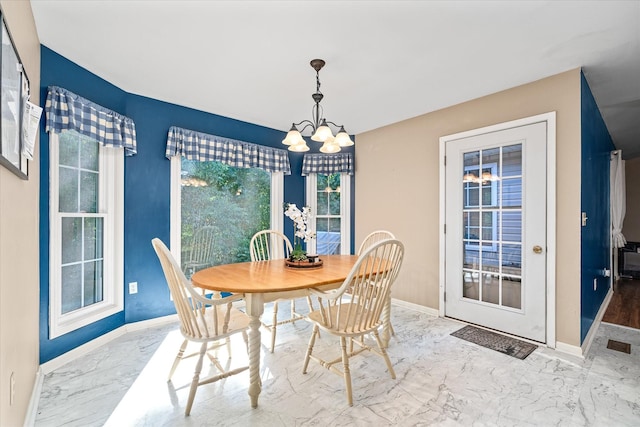 dining space featuring an inviting chandelier