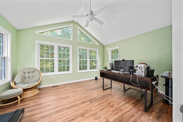 office space with a wealth of natural light, ceiling fan, vaulted ceiling, and hardwood / wood-style floors