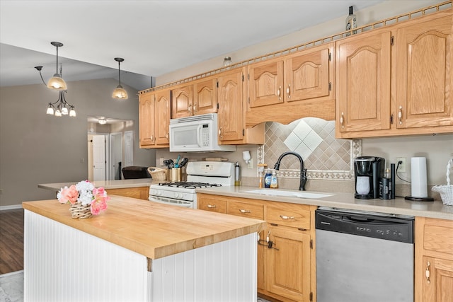 kitchen featuring tasteful backsplash, hanging light fixtures, white appliances, vaulted ceiling, and light hardwood / wood-style floors