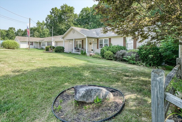 ranch-style house with a garage, a front yard, and covered porch