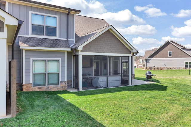 back of property featuring a yard and a sunroom