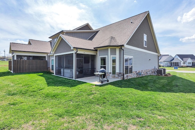 back of property with a patio, a sunroom, a yard, and cooling unit