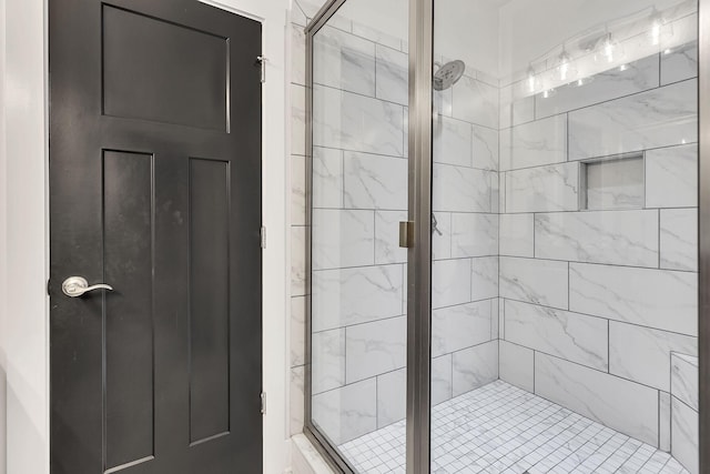 bathroom featuring a shower with shower door