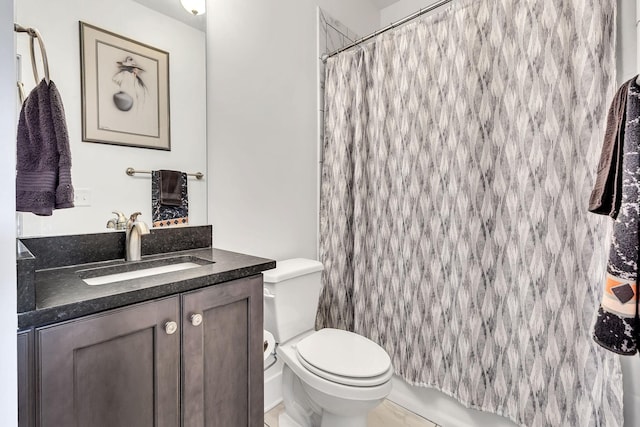 bathroom featuring vanity, toilet, and curtained shower