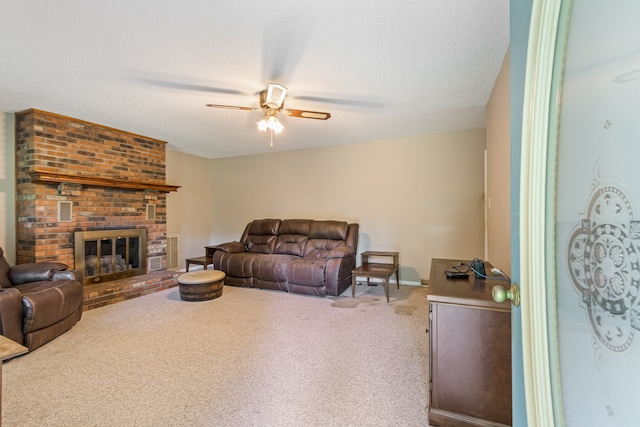 carpeted living room featuring a fireplace, a textured ceiling, brick wall, and ceiling fan