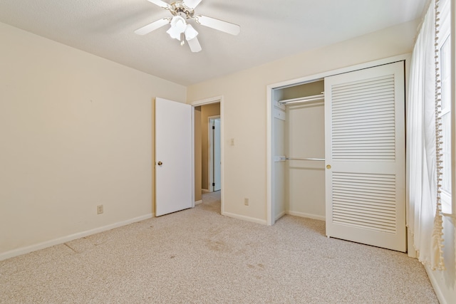 unfurnished bedroom with a closet, ceiling fan, and light colored carpet