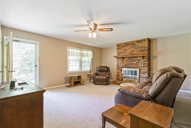 living room with a fireplace, a textured ceiling, carpet flooring, brick wall, and ceiling fan