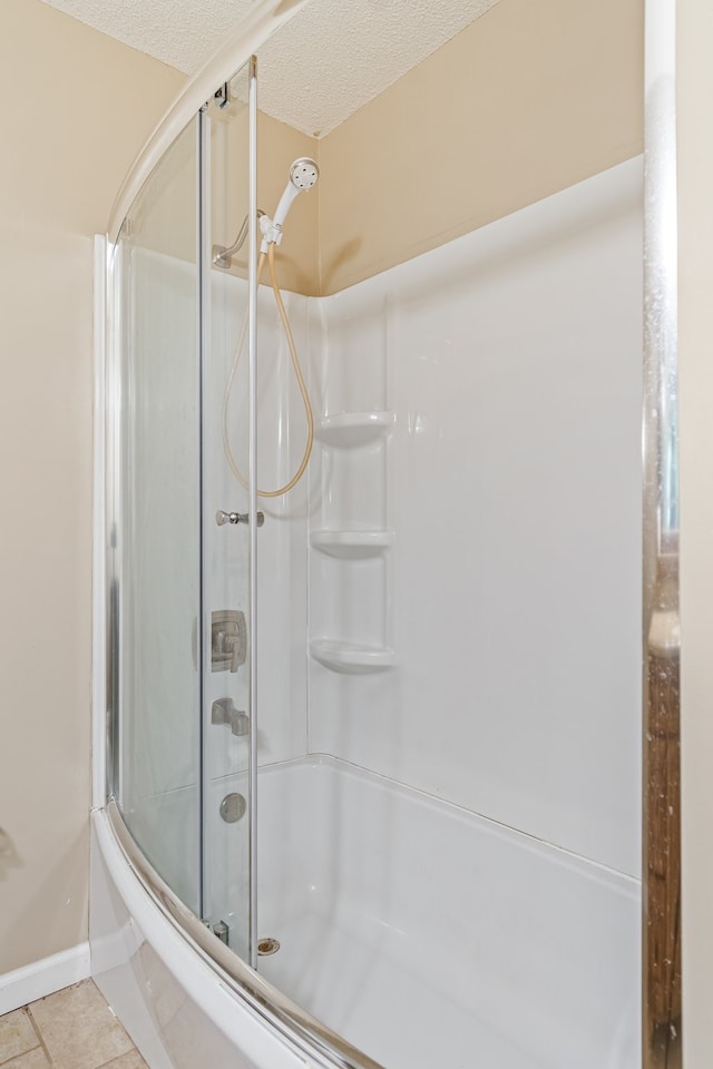 bathroom featuring tile patterned floors and a textured ceiling