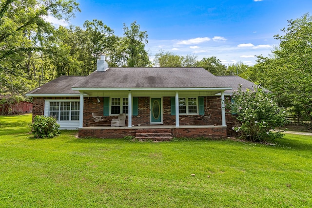 ranch-style house with covered porch and a front lawn