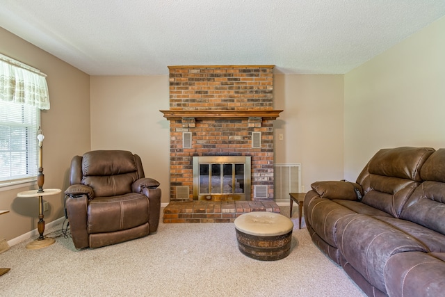 living room featuring a fireplace, carpet, and a textured ceiling