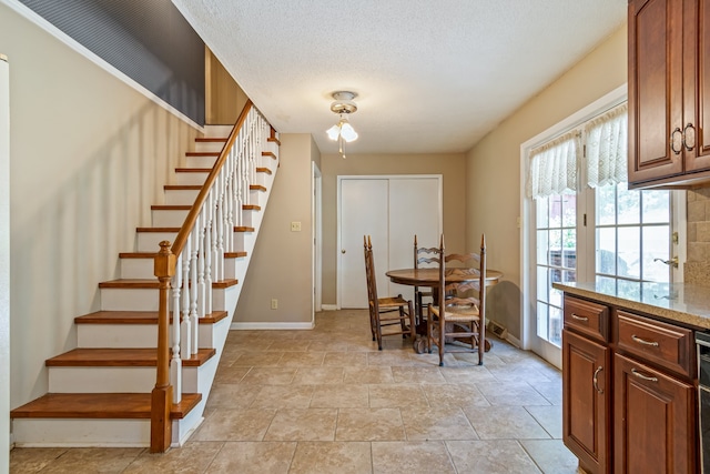 dining area with light tile patterned floors and a textured ceiling