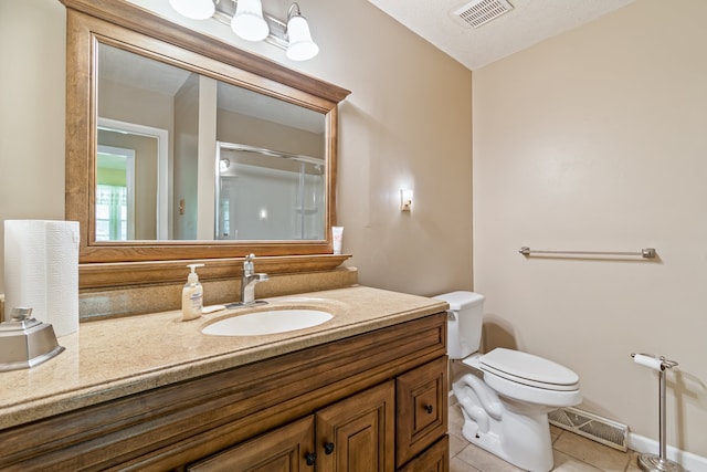 bathroom featuring vanity, toilet, tile patterned floors, and a textured ceiling