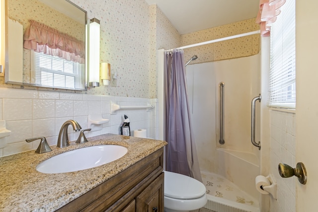 bathroom with toilet, vanity, tasteful backsplash, and plenty of natural light