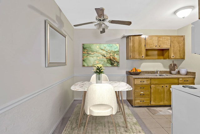 kitchen featuring ceiling fan, white electric range, sink, and light tile patterned floors