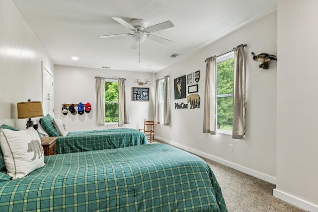 bedroom with carpet flooring, multiple windows, and ceiling fan