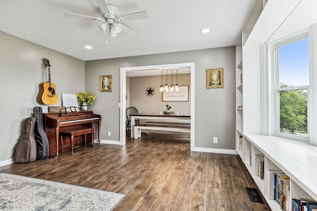 sitting room featuring ceiling fan and dark hardwood / wood-style floors