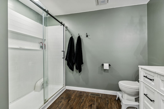 bathroom featuring toilet, hardwood / wood-style floors, and vanity