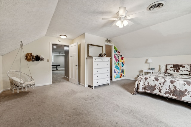 bedroom with a textured ceiling, light colored carpet, vaulted ceiling, and ceiling fan