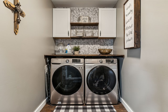 washroom featuring separate washer and dryer, cabinets, and hardwood / wood-style floors