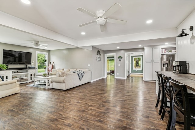 living room with dark wood-type flooring and ceiling fan