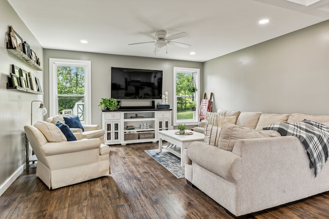 living room featuring ceiling fan and dark hardwood / wood-style flooring