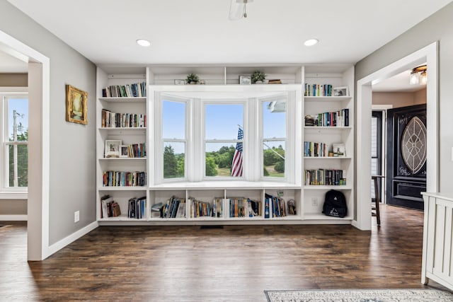 unfurnished room with dark wood-type flooring and built in features