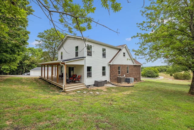 back of house with cooling unit, a wooden deck, and a lawn